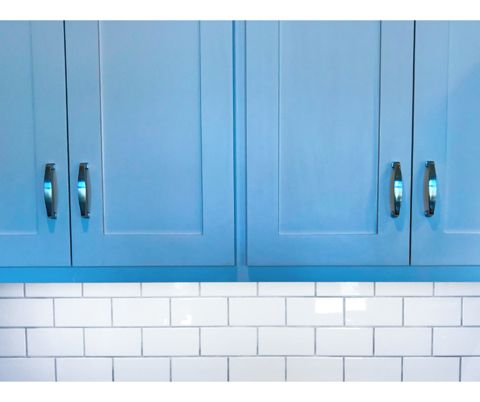 Blue painted kitchen cabinets with new handles