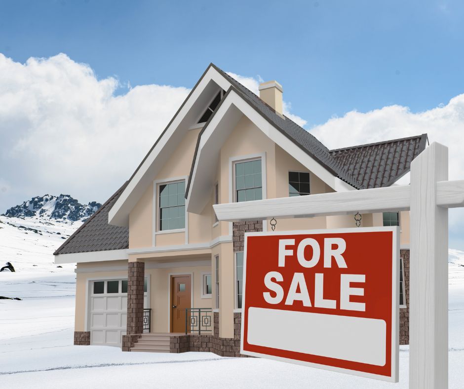 New home with for sale sign in snow 